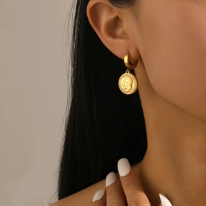 Vintage gold coin portrait embossed stainless steel earrings shown on female model