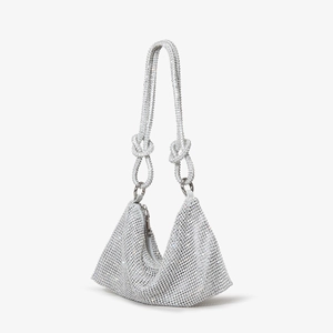 Detail of silver rhinestone hobo bag with knotted handle and sparkling crystals