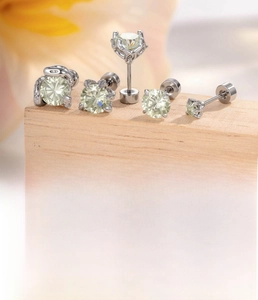 Macro detail of silver titanium steel ear studs set with white zircon and size specs