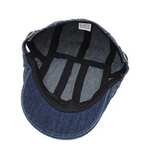 Inside view of a navy blue washed denim ivy cap with inner lining and care label detail