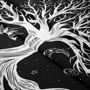 Macro shot of tree of life tapestry showing soft polyester fabric texture and celestial print