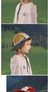 Close-up of kids waterproof sun hat with adjustable cord and cartoon dinosaur patch