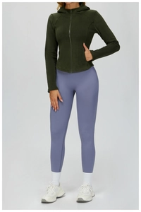 Women's dark green hooded fleece zipper jacket paired with blue yoga leggings