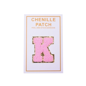 Detail of pink chenille letter K patch with gold glitter edge and self-adhesive backing