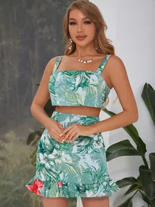 Detailed view of women's tropical print crop top with bow tie back and ruffled mini skirt