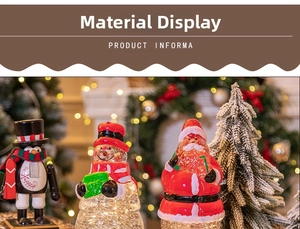 Nahaufnahme von dekorativen Weihnachts-Schneemann- und Weihnachtsmann-Kristallkugeln mit Bokeh
