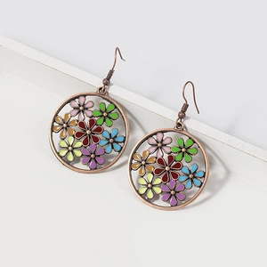 Detail view of retro bronze drop earrings with colorful enamel flowers and镂空 design
