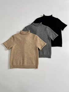 Soft knit short sleeve sweaters in camel, grey, and black showing ribbed knit textures