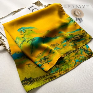 Golden silk square scarf featuring traditional landscape art and smooth texture