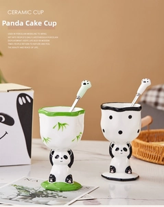 Close-up of creative panda ceramic dessert goblets with matching paw-shaped spoons