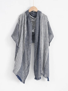 Detail of the navy blue striped men scarf showing soft fabric texture and fringe edges