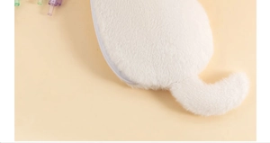 Detail of white plush pencil case featuring soft faux fur and fluffy cat tail zipper charm
