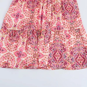 Close-up of bohemian paisley floral print dress with button detail and ruffled seam