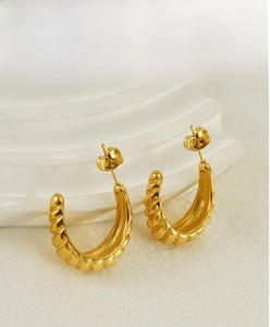 Close-up of 18K gold-plated C-shape earrings with elegant vintage spiral croissant texture