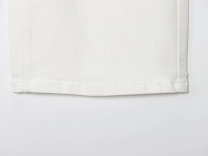 Macro shot of double-stitched hem on high-waist white wide-leg denim jeans