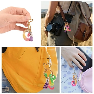 Porte-clés alphabet en résine avec paillettes, fermoir cœur et pompon en situation