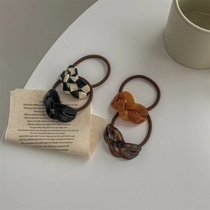 Elastic acetate hair ties with black checkered and amber chain link decorations