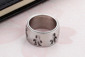 Macro shot of silver rotating chain ring featuring hollow boy and girl silhouette cutouts