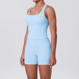 Detail view of light blue yoga set featuring a racerback tank top and shorts with pockets