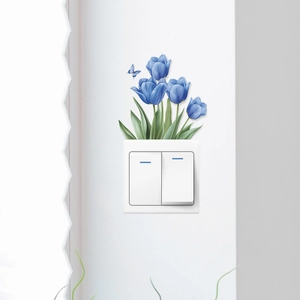 Romantic blue tulip and butterfly wall sticker decorating a white light switch panel