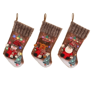 Three LED Christmas stockings with 3D Santa Snowman Reindeer plush figures on white background