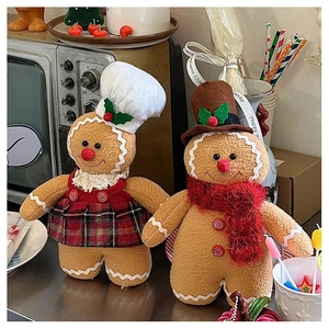 Close-up of a pair of plush Christmas gingerbread dolls in festive outfits with textured fur