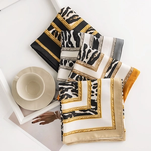 Elegant leopard and zebra print silk scarf set displayed with decorative home accessories