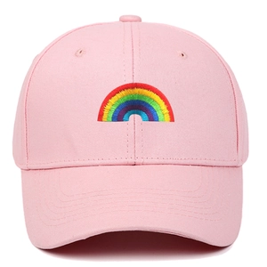 Pink cotton baseball cap featuring a vibrant rainbow embroidery on a clean white background