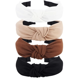 Detailed view of four knotted fabric headbands in white, beige, brown and black