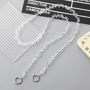 Close-up of crystal beaded crossbody strap with silver metal round spring ring clasps