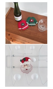 Detail of cloth Christmas tree ornaments with red and green sweaters and Santa Claus