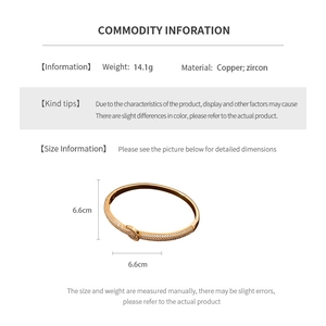 Detail view of 18K gold plated copper bangle with micro-paved zircons and knot design