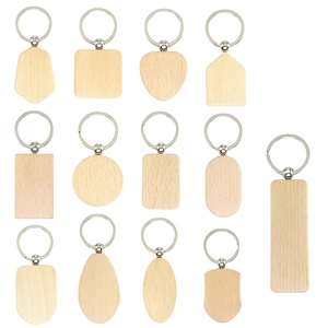 Collection of beech wood keychains in various geometric shapes on a white background