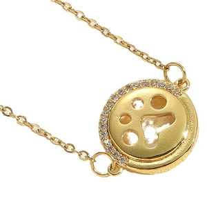 Golden titanium steel necklace with a round hollow animal paw pendant and white zircons