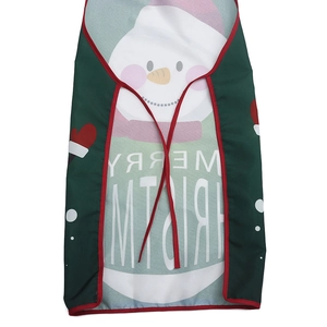 Detail view of a green Christmas apron featuring a large snowman and Merry Christmas print
