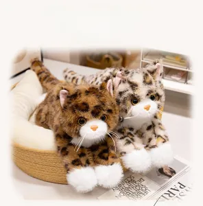 Close-up of realistic plush kittens with leopard patterns in a cozy woven pet bed