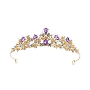 Detailed view of luxury gold crown with purple and white rhinestones for brides