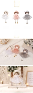 Detailed view of handmade angel doll ornaments with lace skirts and metallic bells
