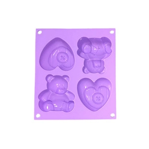 Detail view of purple silicone popsicle mold with two heart and two teddy bear shapes