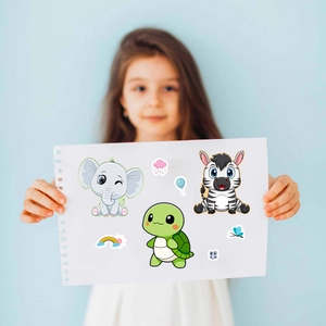 Girl holding creative DIY animal face-changing stickers including elephant and zebra
