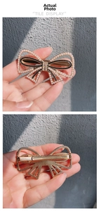 Detail view showing the front and back of a golden bow hair clip with pearls and rhinestones