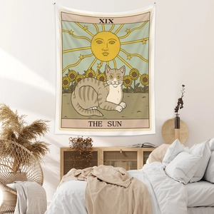 Detail of bohemian sun tarot cat tapestry hanging in a cozy minimalist bedroom setup