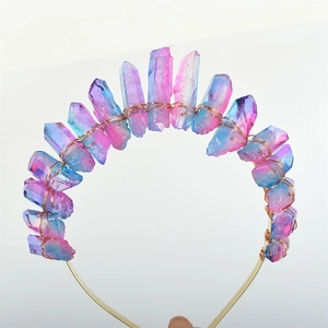 Detail view of handmade gold wire crown with vibrant blue and pink crystal points