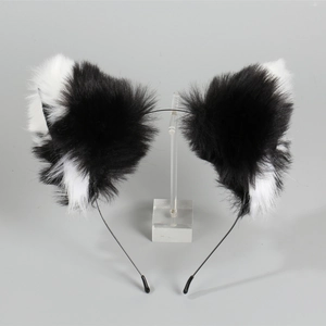 Close-up of black and white plush cat ears headband on a clear display stand