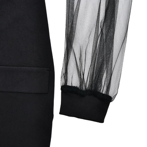 Close-up detail of sheer mesh sleeve and ribbed cuff on a black bodycon mini dress