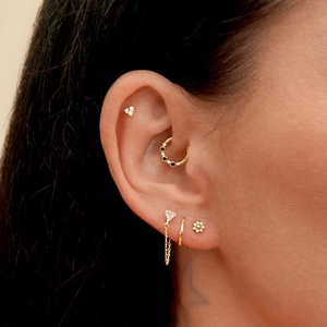 Detailed close-up of S925 silver star cartilage earrings with gold chain and crystals