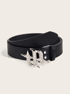 Close-up of black leather belt featuring a vintage silver buckle with sparkling rhinestones