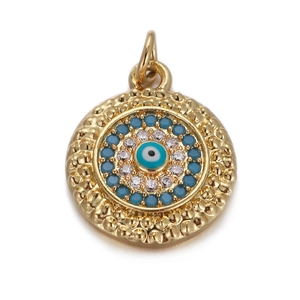 Macro shot of gold-plated evil eye pendant with blue crystals for DIY jewelry making