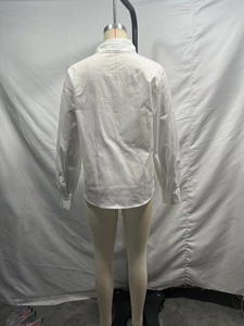 Detail view of white shirt back with lace collar trim on a mannequin for women