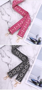Detailed close-up of ethnic woven wide purse straps with golden lobster clasps